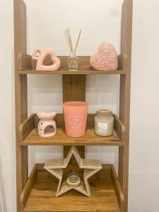 a wooden shelf with a star and other items on it at 4c Gaia Lane in Lichfield
