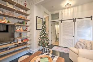 a living room with a christmas tree in the corner at Historic 1900 Cottage in Downtown St Augustine! in St. Augustine