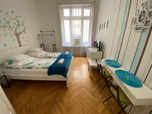 a bedroom with a bed and a desk at Studio 4U Apartment in Budapest