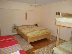 A bed or beds in a room at Chalupa Kucbel
