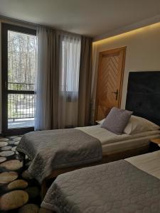 Posteľ alebo postele v izbe v ubytovaní Rytebłota Resort & Spa