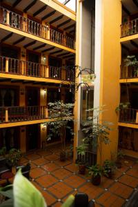 a courtyard in a building with potted plants at Hotel Catedral in San Cristóbal de Las Casas