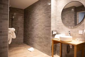 a bathroom with a sink and a mirror at Hôtel Royal - Centre Comédie in Montpellier