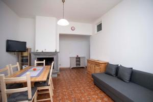 a living room with a couch and a table at Ortensia e Glicine - Goelba in Seccheto