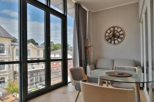 a living room with a table and chairs and a window at Seaside Seaside Appartement 18 in Timmendorfer Strand