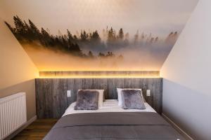 Ein Bett oder Betten in einem Zimmer der Unterkunft Przystanek Babia Apartamenty