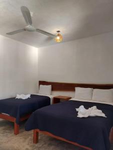 Postel nebo postele na pokoji v ubytování Hotel Xa´an Bacalar