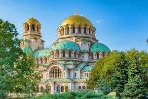 a large building with two domes on top of it at Spacious Apartment next to South Park Просторен Апартамент до Южен Парк Top Location in Sofia