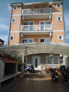 a building with a large umbrella in front of it at Guest House Berto in Crikvenica