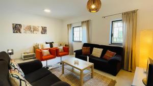 a living room with a couch and a table at Bicos 101 - Shared Pool - 4 Guests - Albufeira in Albufeira