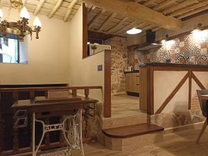 a tasting room with a wooden table and a stage at El Cascanueces - Casa Rural in Candelario