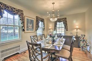 a dining room with a table and chairs and windows at Homeplace with Yard - 10 Mi to Jenny Wiley! in Paintsville