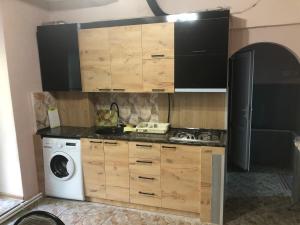 a kitchen with a washing machine and a washer at Metax House Yerevan in Yerevan +5 photos