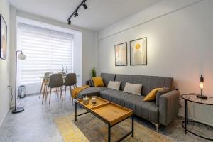 a living room with a couch and a table at Lux&Cool Obispo Orberá - Santa Rita in Almería