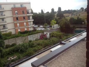 a view from the balcony of a building with a garden at Hotel Le Jardin in Lens