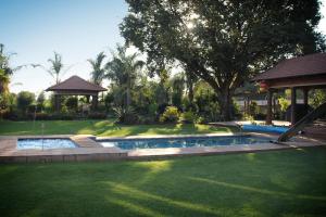 a swimming pool in a yard with a gazebo at De Zoete Rust Guesthouse in Centurion