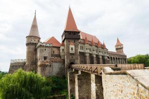 a large castle with towers and a bridge at Perfect Stay Apartment Petrosani in Petroşani