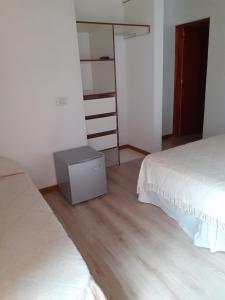 a bedroom with a bed and a dresser in it at Posada Shalimar in Villa Icho Cruz