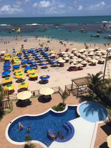 an aerial view of a beach with umbrellas and people at PLAGE DU PORTO 204- Beira mar, centrinho turístico in Porto De Galinhas