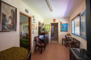 a room with a bed and a table and chairs at Chacra La Mondiola del Este in Ciudad de la Costa