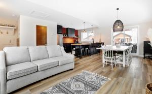a living room and kitchen with a couch and a table at 01 Chemin des Cascades in Stoneham