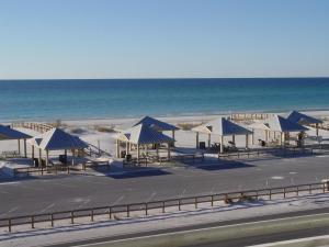 a group of blue and white tents on the beach at Beautiful Beach Condo in Pensacola Beach