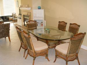 a dining room with a glass table and chairs at Beautiful Beach Condo in Pensacola Beach