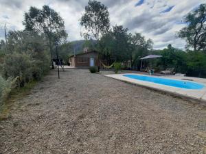 a home with a swimming pool and a house at MarraHOME in El Challao