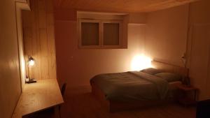 a bedroom with a bed and a table and lights at T2 Rdc, jardin, calme, parking, idéalement placé in Issoire