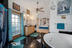 een grote badkamer met een bad en een slaapkamer bij The Starlight Tower Hot Tub Suite with 8-Jet Massage Shower and Amazing Views in Fort Atkinson +13 foto's