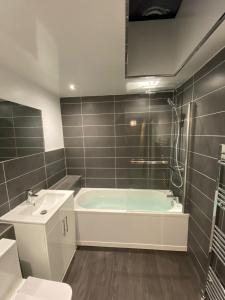 a bathroom with a tub and a toilet and a sink at Sunderland Self Catering 4 - City Centre Townhouse with free parking in Sunderland
