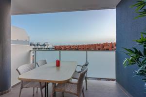 a table and chairs on a balcony with a view at El Medano, La Tejita in El Médano