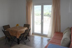 a dining room with a table and chairs and a couch at Apartments Marinko in Stari Grad +128 photos