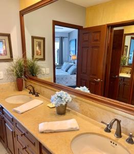 a bathroom with two sinks and a large mirror at Rocky Point Sonoran Resorts in Puerto Peñasco