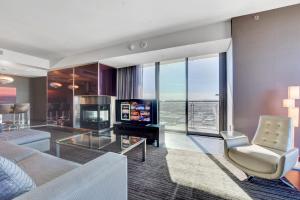 a living room with a couch and a television at Private Luxury Panoramic Suite at Palms Place in Las Vegas