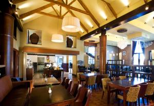 a dining room with wooden tables and chairs at The Farmers Kitchen Hotel in Wexford