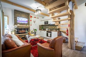 a living room with a couch and a table at Domki Sywor in Kościelisko