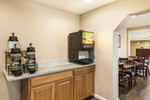 a room with a bar with a television on a counter at Quality Inn & Suites near NAS Fallon in Fallon