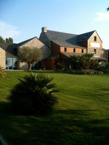 a large house with a green lawn in front of it at Domaine de la Barbinais in Saint Malo