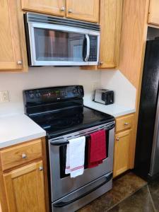 a kitchen with a stove and a microwave at Chateau 18 in Hammond