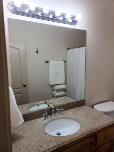 a bathroom with a sink and a large mirror at Chateau 18 in Hammond