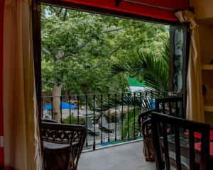 a balcony with chairs and a view of a garden at Zihuatanejo studio in Zihuatanejo