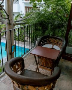 a chair and a table on a balcony at Zihuatanejo studio in Zihuatanejo
