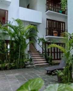 a building with stairs and plants in a courtyard at Zihuatanejo studio in Zihuatanejo