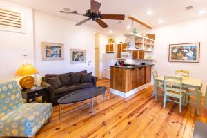 a living room with a couch and a table at Hibiscus Coffee & Guesthouse in Santa Rosa Beach