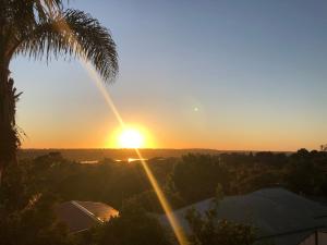 a sunset from the roof of a house at Lakeside Retreat in Perth