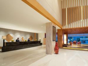 a lobby of a hotel with a reception desk at Radisson Golf & Convention Center Batam in Batam Center