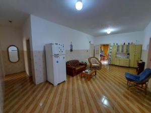 a living room with a couch and a refrigerator at Pouso do Bizuca in Tiradentes +47 photos