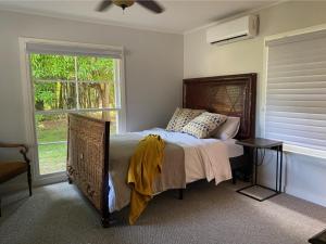 a bedroom with a bed and a table and a window at Siesta Key Waterfront Estate W Pool Privacy! in Sarasota +109 photos