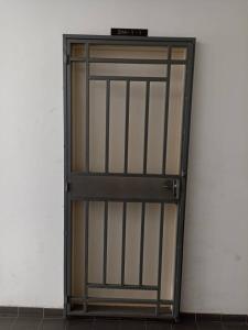 a door with a metal gate in a room at Homestay uuc in Kota Kinabalu